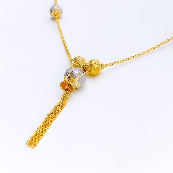 This luminous 22k gold necklace features an exquisite dangling design that combines the elegance of yellow and white gold. Weighing 9.0 grams, it offers a luxurious yet comfortable feel. The radiant blend of yellow and white gold enhances its sophisticated and modern appeal. With a necklace length of 18 inches and a drop length of 1.5 inches, this piece is perfect for adding a touch of refined style to any outfit. The secure lobster lock ensures confident and comfortable wear. Elevate your jewel Luxury 22k White Gold Necklaces, Gold Dual-tone Necklace For Formal Occasions, Elegant Dual-tone Gold Necklace, Elegant Gold Dual-tone Necklace, Elegant Dual-tone Yellow Gold Necklace, Dual-tone Gold Plated Necklace, 22k Gold Yellow Dangle Jewelry, Elegant 22k Gold Yellow Chain Necklace, Elegant Yellow Rectangular Necklace