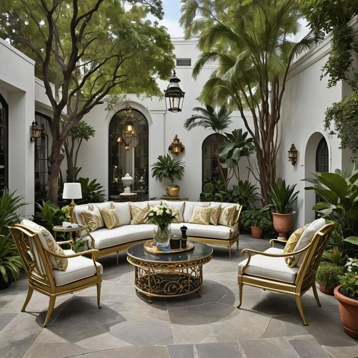 a living room filled with lots of furniture and plants in front of a white building