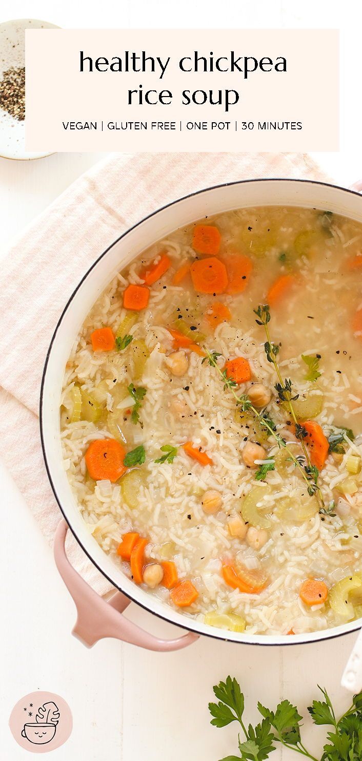 a bowl of chicken rice soup with carrots and parsley