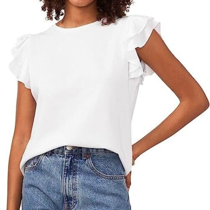 Bring On A Chic Update To Your Classic Casual Style Wearing The Vince Camuto Tiered Ruffle Sleeve Crew Neck Tee. Cotton, Spandex Pullover Style With Crew Neck. Tiered Ruffled Cap Sleeves. 87% Cotton, 13% Polyester. Machine Washable Imported White Cotton T-shirt With Flutter Sleeves, White Flutter Sleeve Trendy Top, Relaxed Fit Tops With Ruffles And Flutter Sleeves, Summer Ruffled Relaxed Fit T-shirt, Summer Relaxed Fit Ruffled T-shirt, Casual Flutter Sleeve Top With Ruffles, Summer Ruffle T-shirt With Flutter Sleeves, Casual Ruffle Top With Flutter Sleeves, Casual Ruffled Flutter Sleeve Tops