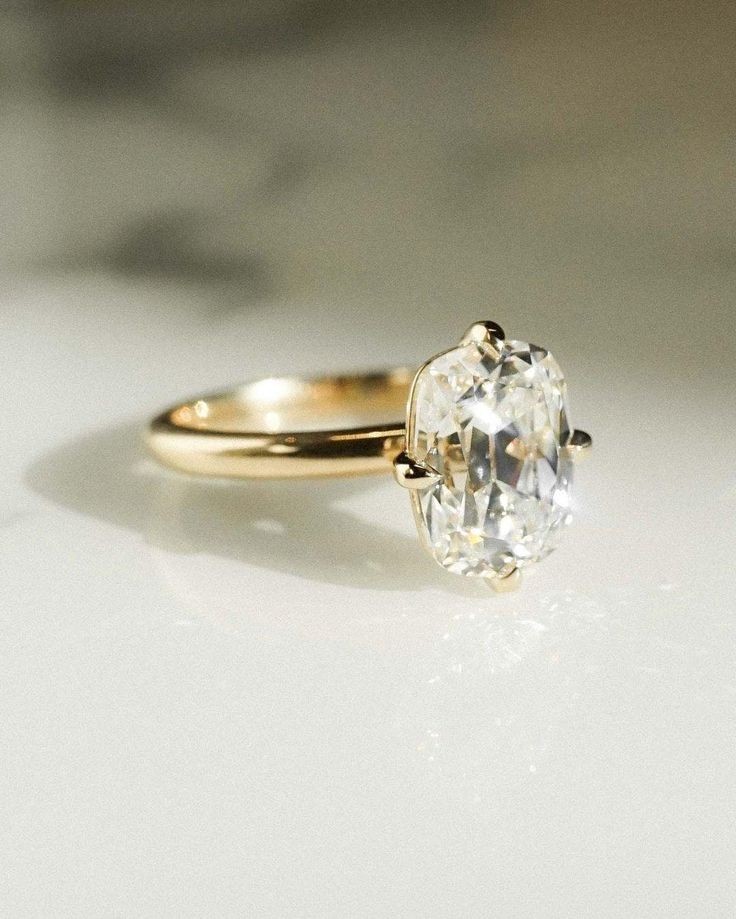 a close up of a diamond ring on a table