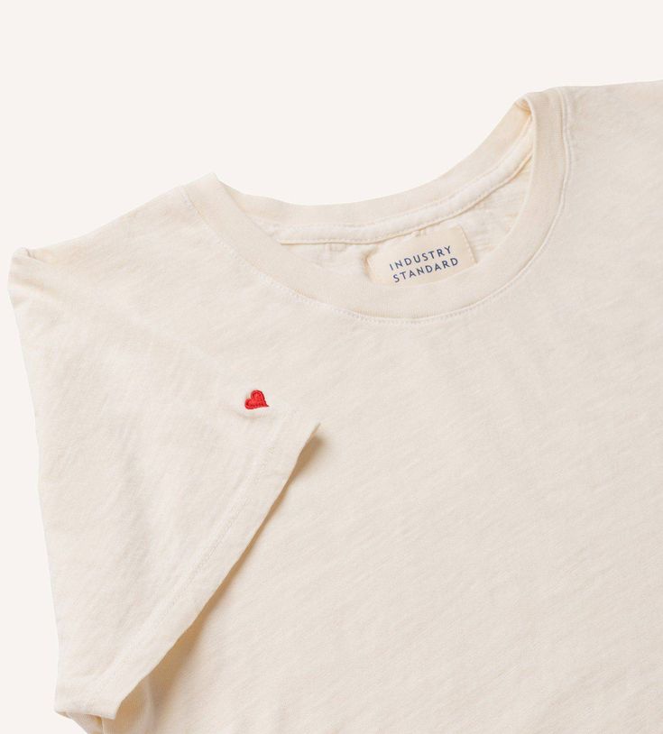 An ultra soft, luxe tee with a tiny red heart embroidered on the sleeve. Made of a lightweight, textured organic cotton and modal blend. Slim but not tight. It fits just right. Embroidered Valentines Shirt, Heart Tshirt, Embroidery Shirt, Fig Jam, Heart Tee, Embroidered Tee, Valentine T Shirts, Simple Tshirt, Fashion Event