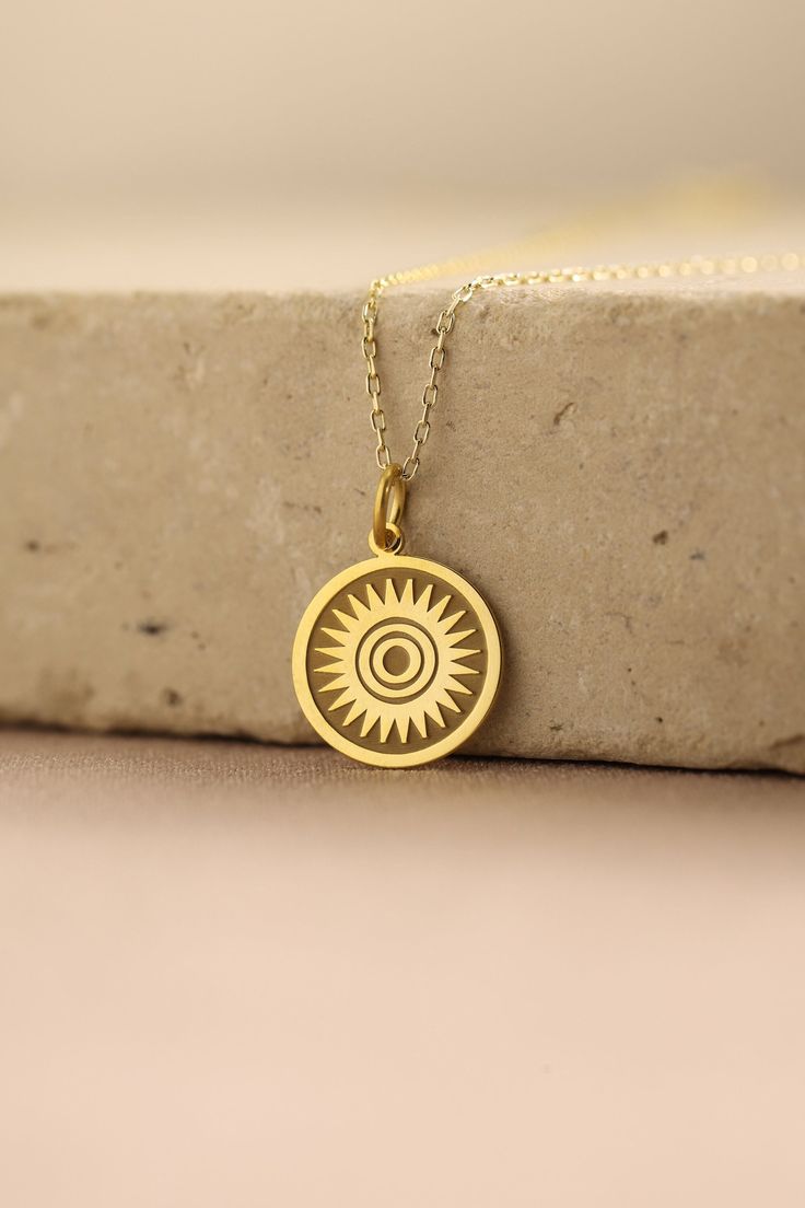 Gold Sun Pendant - Sun Gold Necklace ● Material of pendant: Solid Gold 14k ( REAL GOLD ) ● Metal Stamp: 14k ( REAL GOLD ) ● The pendant is available in 5 sizes: - 12,7 mm / 0.5 inches (Diameter) - 14,0 mm / 0,55 inches ( Diameter ) In the photos - 15,3 mm / 0.6 inches ( Diameter ) - 16,5 mm / 0,65 inches ( Diameter ) - 19,1 mm / 0,75 inches ( Diameter ) ( In the photos the size is 14mm / 0.55 inches Diameter ) ( Jump Ring inner diameter: 4 mm ) ● Material of chain: Solid gold 14k ( REAL GOLD ) I 14k Gold Amulet Charm Necklace With Round Pendant, 14k Gold Spiritual Round Pendant Charm Necklace, 14k Gold Engraved Amulet Charm Necklace, Spiritual 14k Gold Charm Necklace With Round Pendant, 14k Stamped Amulet Style Round Pendant Necklace, 14k Gold Round Necklaces With Charms, Yellow Gold Medallion Jewelry As A Gift For Her, Engraved 14k Gold Amulet Charm Necklace, 14k Gold Symbolic Charm Necklace With Round Pendant