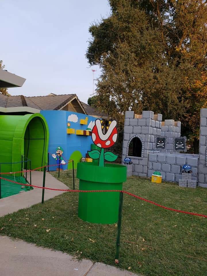 there is a green potted plant in the middle of this play area that looks like a mushroom house