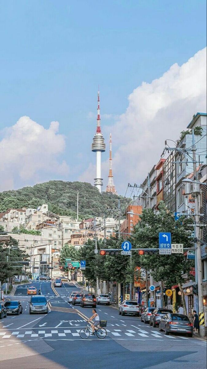 a city street with cars and people on bikes