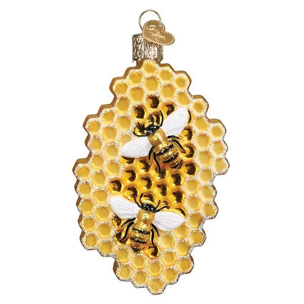 a glass ornament with two bees on it