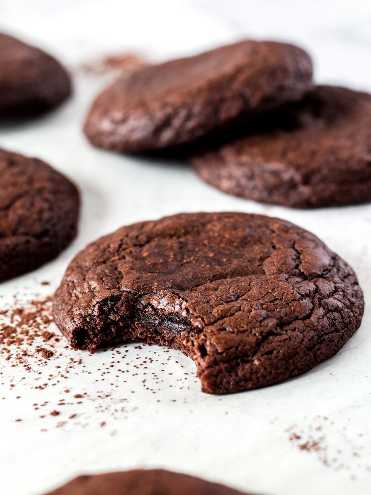 several chocolate cookies with one broken in half