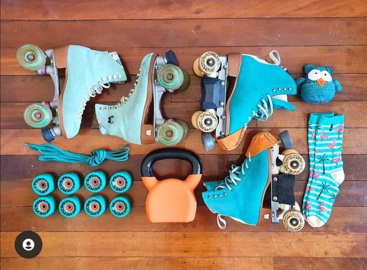 various skateboard and roller skates on a wooden floor