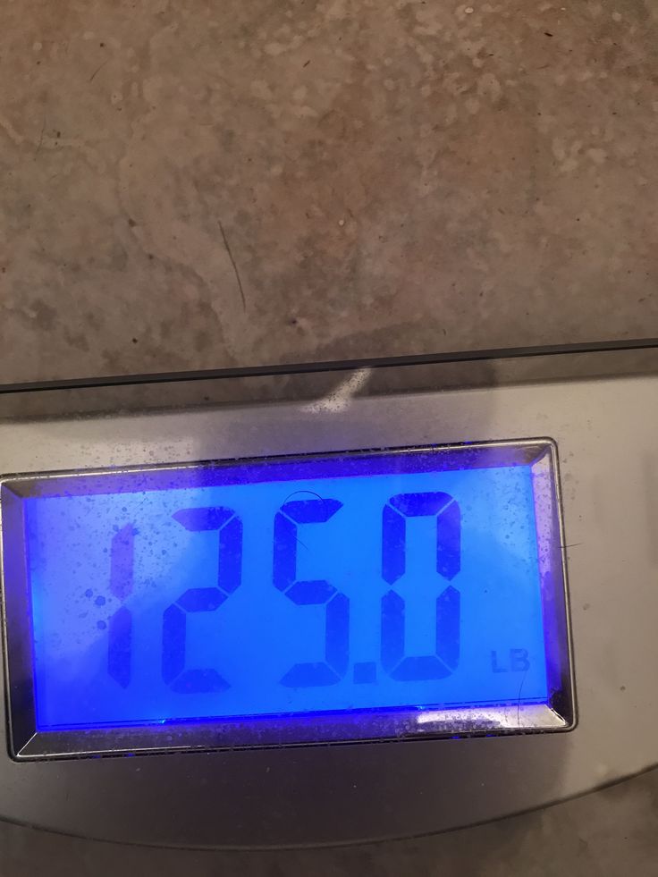 a digital clock sitting on top of a scale