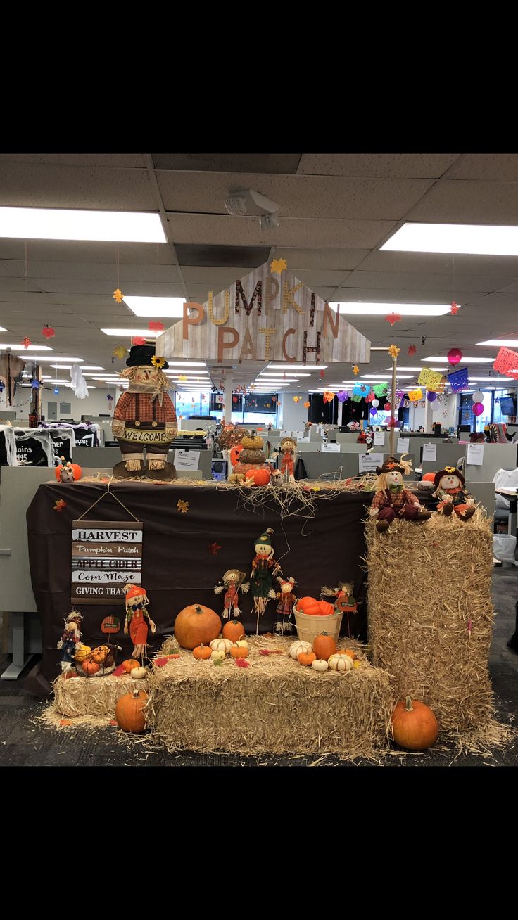 an office decorated for halloween with hay bales and pumpkins