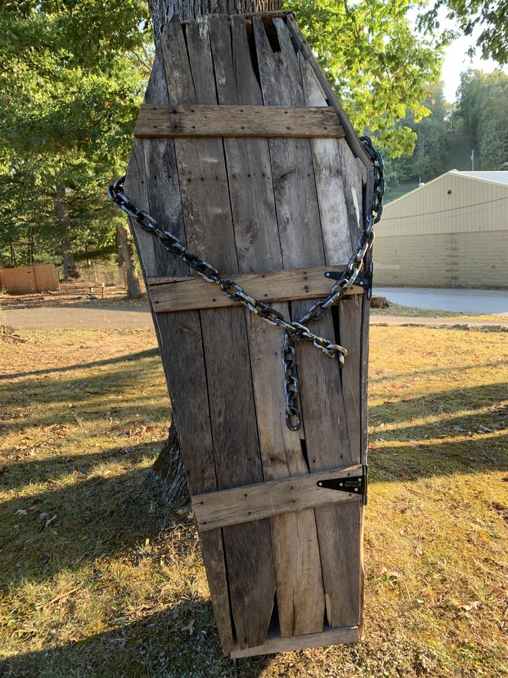 a wooden structure with chains attached to it