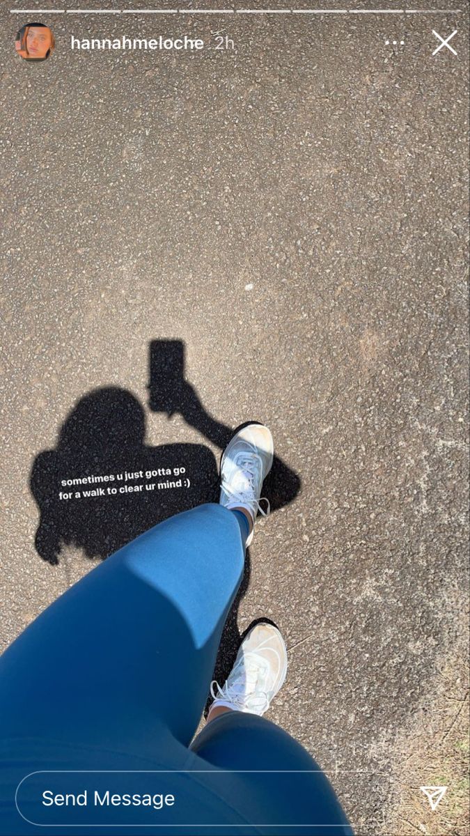 the shadow of a person standing next to a motorcycle