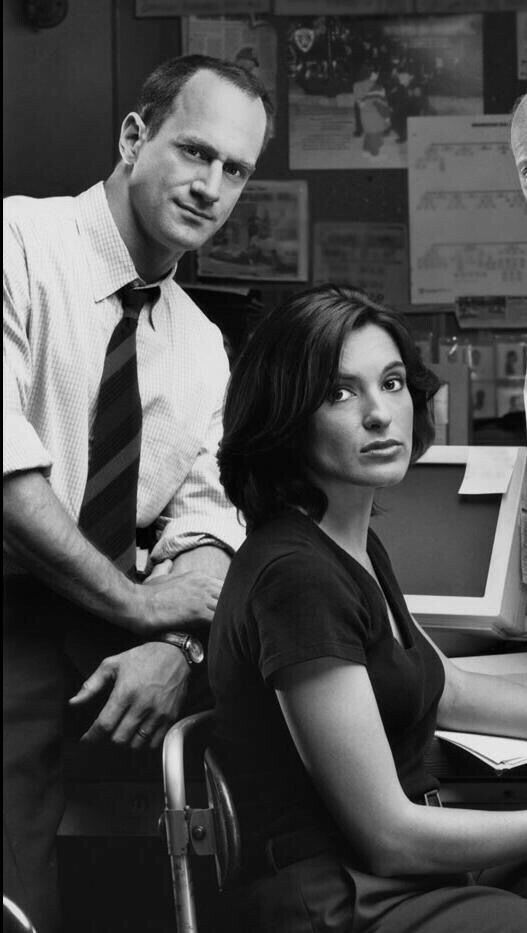 two men and a woman sitting at a desk