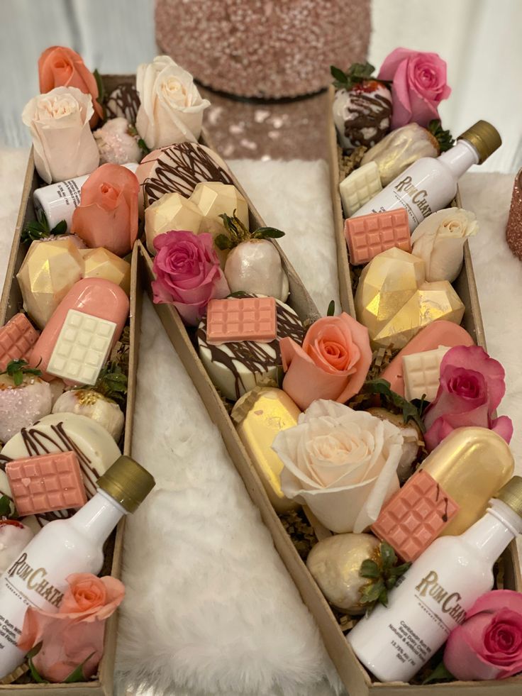 two wooden boxes filled with different types of bath products and flowers on top of a white furnishing