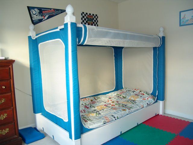 a blue and white bunk bed in a child's room with colorful carpeting