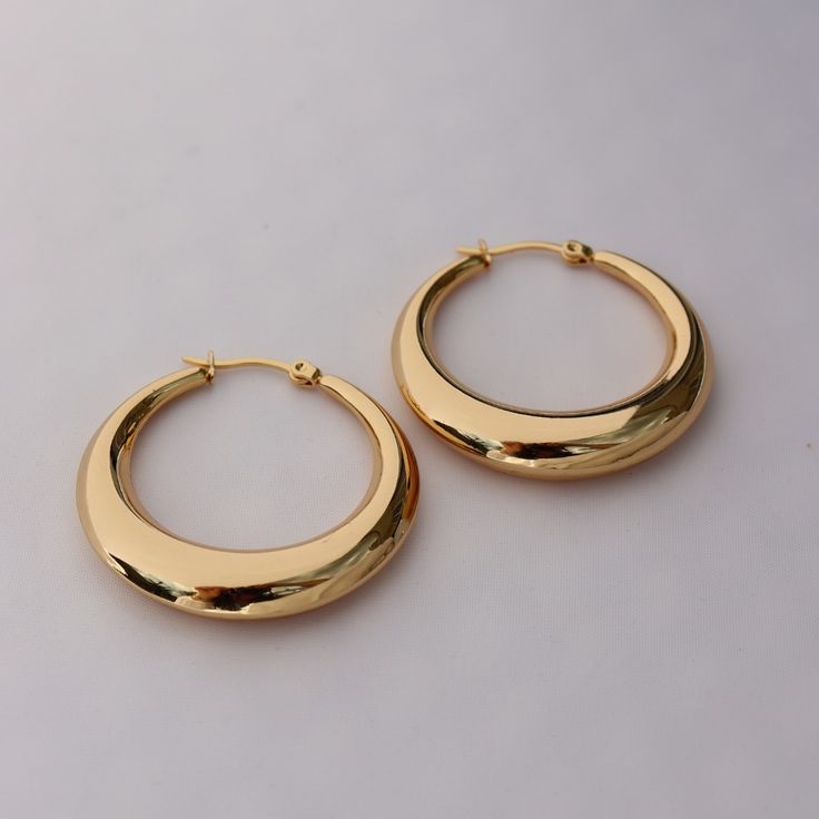 For a simple pair of earrings that always look fabulous, choose these light weight hoop earrings. With a hollow middle, made from stainless steel and finished with 14kt yellow gold plating, these earrings are an essential for every jewellery box. We love the shiny, classic yellow gold and the lightweight feel for all day comfort. Shop these versatile earrings for yourself or for someone special to make a fabulous gift! Clean with a jewellery polishing cloth. Store in a safe place separately to a Minimalist Polished Finish Hoop Earrings For Everyday Luxury, Modern Rose Gold Hoop Earrings For Everyday Wear, Modern Tarnish-resistant Hoop Earrings, Minimalist 14k Gold Hoop Earrings With Shiny Finish, Modern Rose Gold Tarnish Resistant Hoop Earrings, Modern Rose Gold Tarnish-resistant Hoop Earrings, Modern Tarnish-resistant Rose Gold Hoop Earrings, Everyday Metal Earrings With Polished Finish, Minimalist Metal Hoop Earrings With Polished Finish