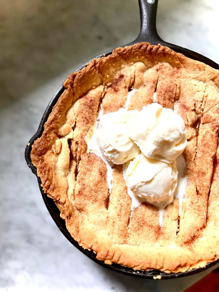 a skillet filled with ice cream on top of a counter