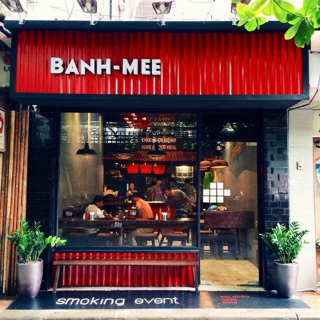 the entrance to banh - mee restaurant with red and black awnings