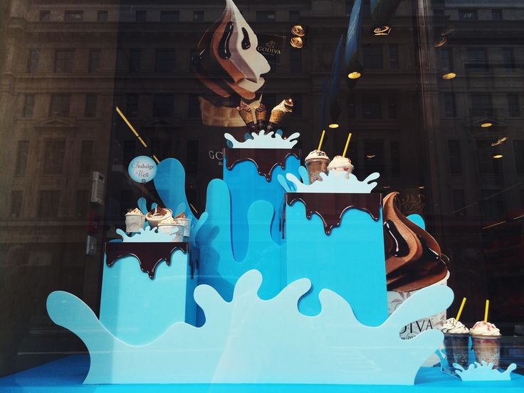 an ice cream shop window display with blue and white frosting