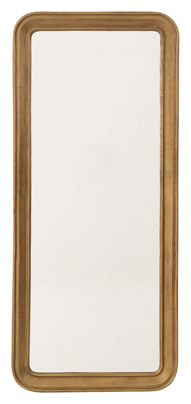 a gold framed mirror sitting on top of a white wall