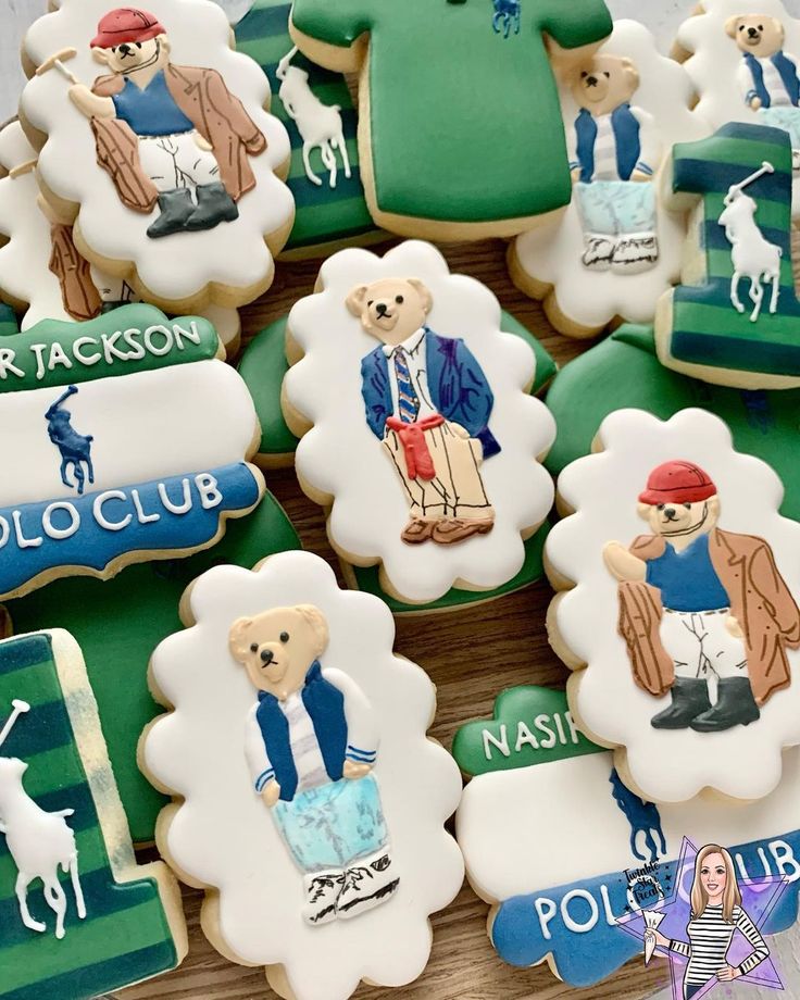 some decorated cookies are sitting on a wooden table with name tags and other items in the shape of teddy bears