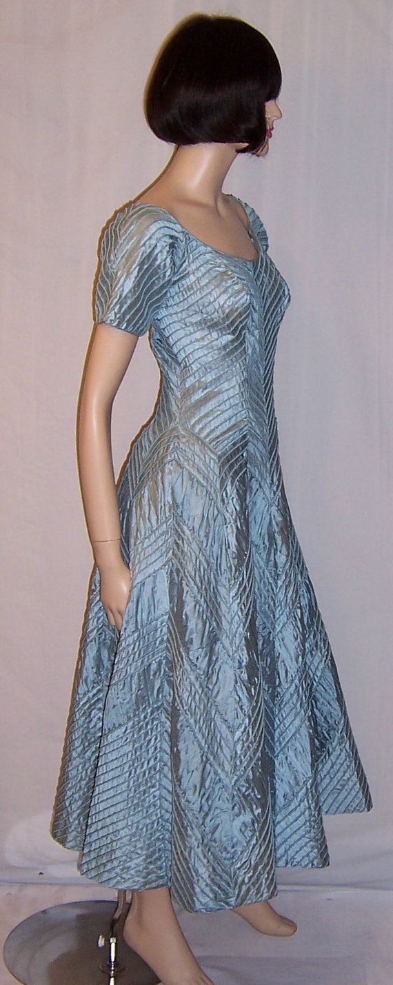 This Ceil Chapman 1950s creation, is one of the most amazing, couture-like gowns, that I have had the privilege of finding and purchasing. The gown, ice blue in color, has a very flattering scooped neckline, short sleeves, tightly fitted bodice, side zipper for closure, full skirt, and is Light Blue Fitted A-line Evening Dress, Fitted Light Blue Evening Dress, Fitted A-line Light Blue Evening Dress, Light Blue Evening Dress With Fitted Bodice, Vintage Fitted Ball Gown Evening Dress, Fitted Vintage Ball Gown Evening Dress, Fitted Light Blue Evening Gown, Formal Fitted Light Blue Evening Dress, Light Blue Fitted Evening Dress For Formal Occasions