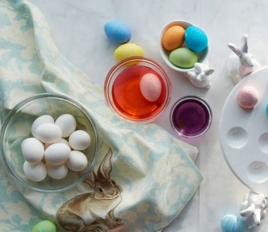 an assortment of easter eggs in bowls on a table