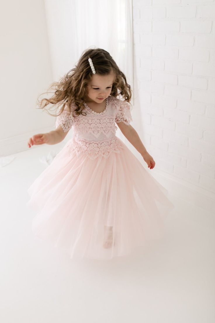 The Perfect Sienna Flower Girl Dress with very soft blush pink lace on the neckline and floor-length tulle skirt adds extra elegance to the dress. Fitted Lace Dress With Lace Sleeves For Dress-up, Princess Style Lace Dress For Dress-up, Princess Dress With Lace Bodice And Tulle For Dress-up, Tulle Dress With Lace Trim For Dress-up, Elegant Bridesmaid Tutu Dress With Lace Trim, Spring Tulle Dress With Delicate Lace, Princess Bridesmaid Dress With Lace Trim, Wedding Tutu Dress With Lace Bodice, Bridesmaid Princess Dress With Lace Trim