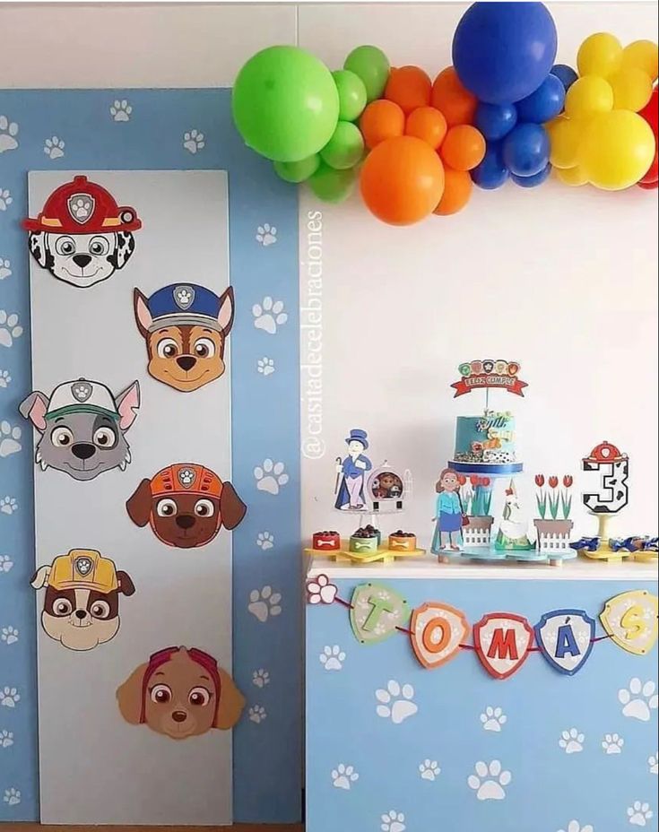 a birthday party with paw patrol decorations, balloons and paper cutouts on the wall