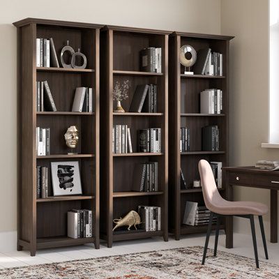 a bookcase with many books on top of it