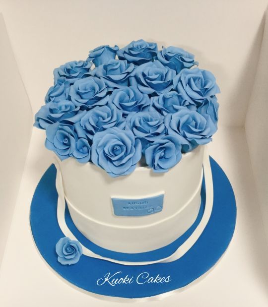 a white box with blue roses in it