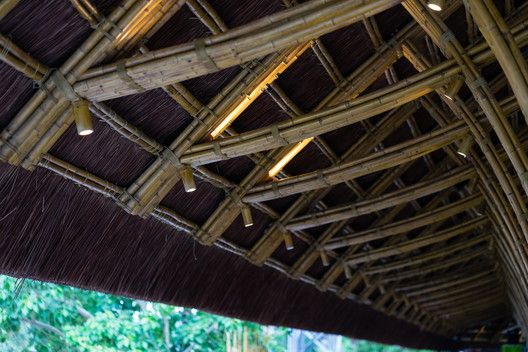 the inside of a bamboo roof with lights