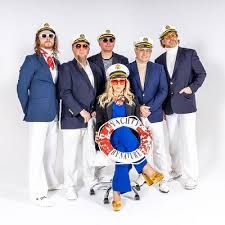 a group of people standing next to each other in front of a white background wearing hats and sunglasses