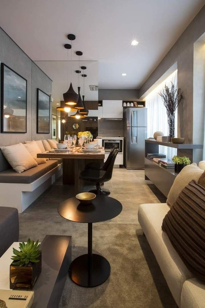 a living room filled with furniture and a dining table next to a kitchen counter top