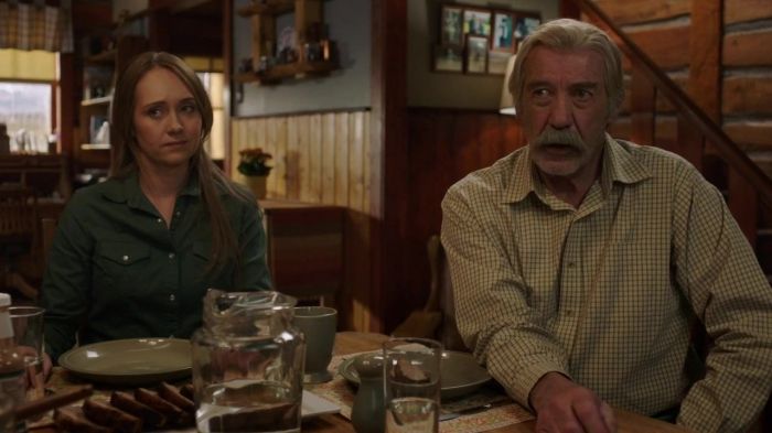 an older man and woman sitting at a table in a restaurant with food on it