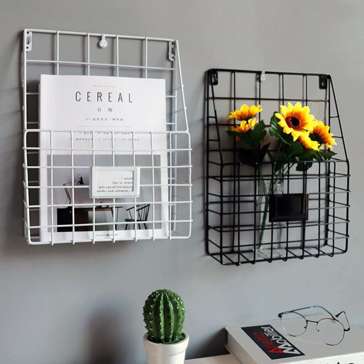 some yellow flowers are sitting in a vase on a shelf next to a book and glasses