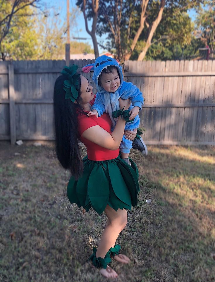 a woman holding a small child in her arms