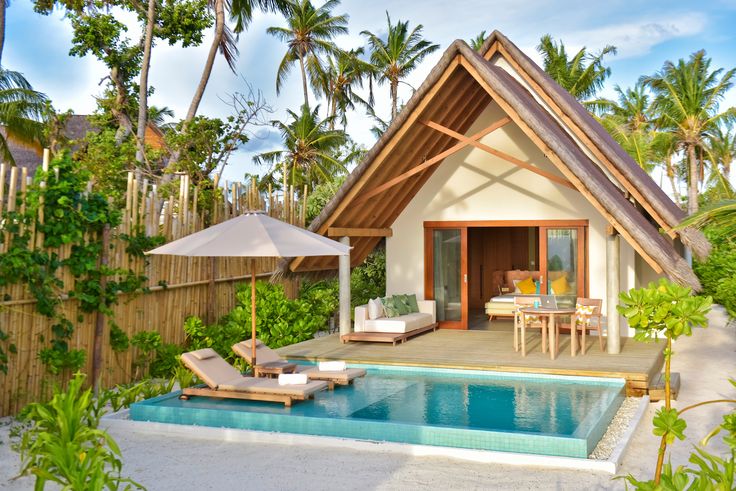 a small house with a swimming pool in the backyard