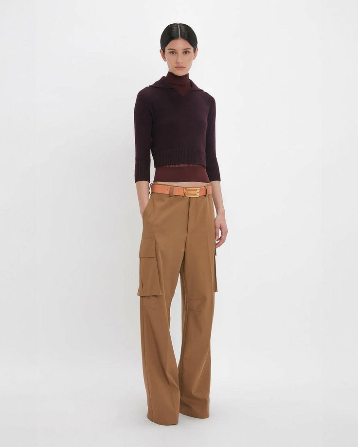 FINAL SALE The Relaxed Cargo Trouser by Victoria Beckham is a loose fitting trouser featuring cargo style pockets, red contrast details, and dart detailing on the knees. Fly front with zip Waistband with 5 belt loops Cargo style pockets on side of leg Right back has welt pocket with white contrast stitch pocket Relaxed fit. For a more fitted silhouette, we advise taking a size down The model height is 178cm and is wearing a size UK6 100% Cotton Dry Clean Only Made In Lithuania #1324WTR005597B 2024 Wardrobe, Double Layer Top, Red Bar, Layer Top, Cargo Style, Wardrobe Ideas, Polo Neck, Military Inspired, Cargo Trousers