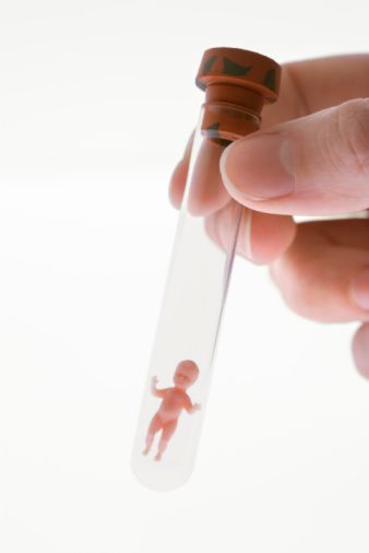 a person is holding a syringe with a small figure on it's side