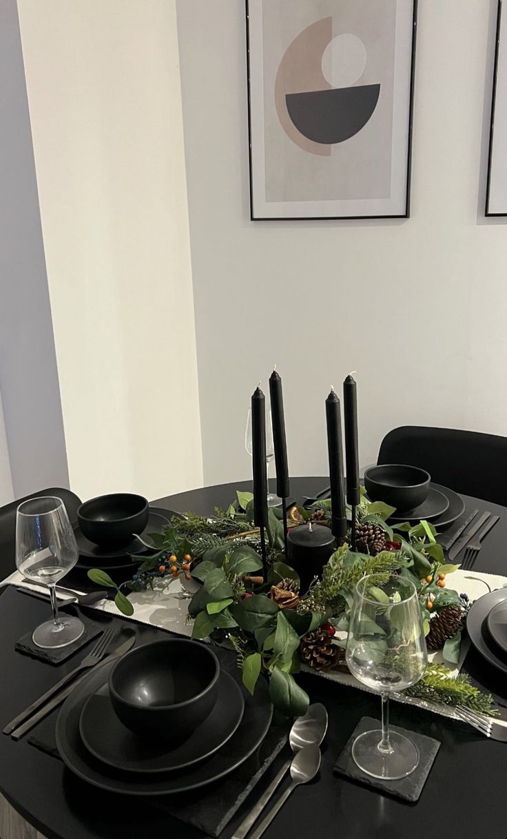 a black table set with place settings and plates