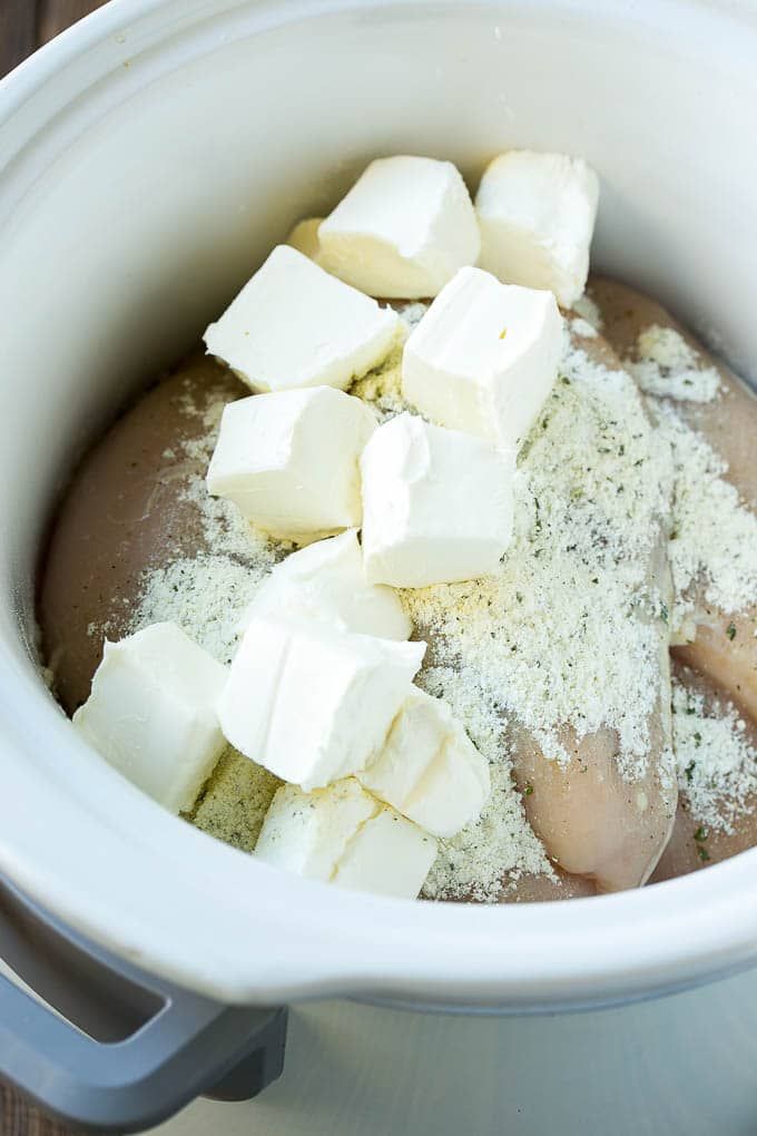 there are many cubes of food in the crock pot with some seasoning on top