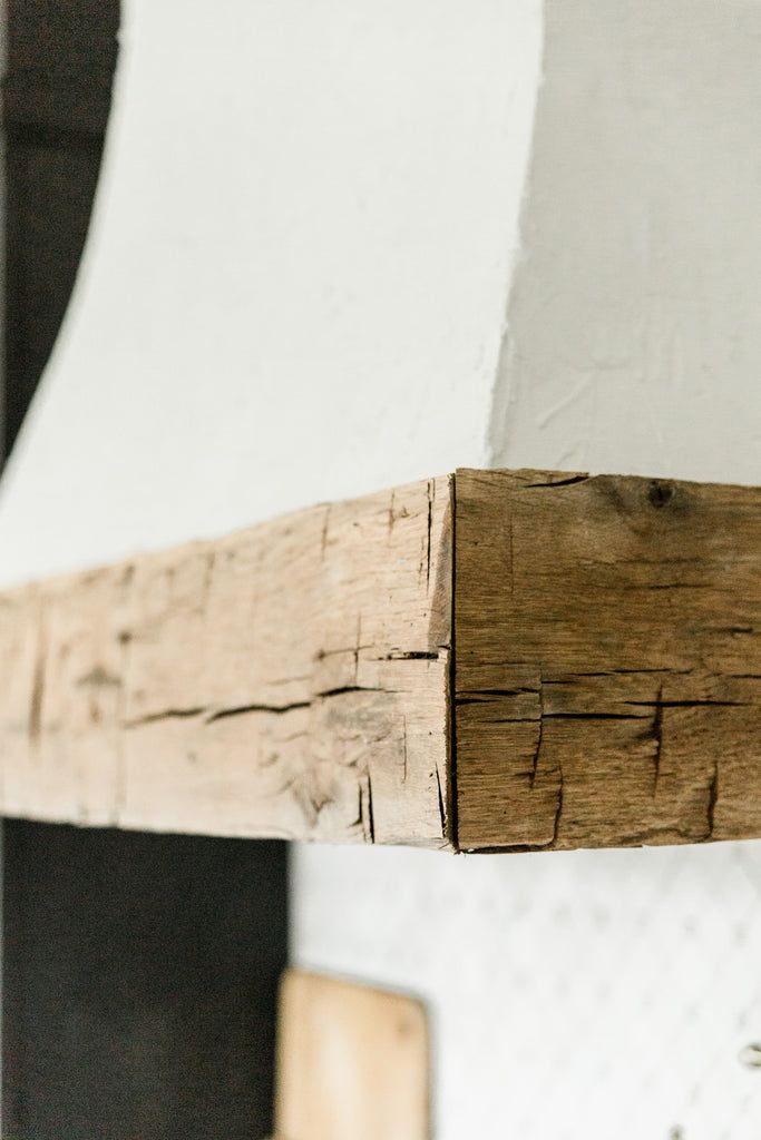 a close up of a wooden beam on a wall with white paint and wood grain