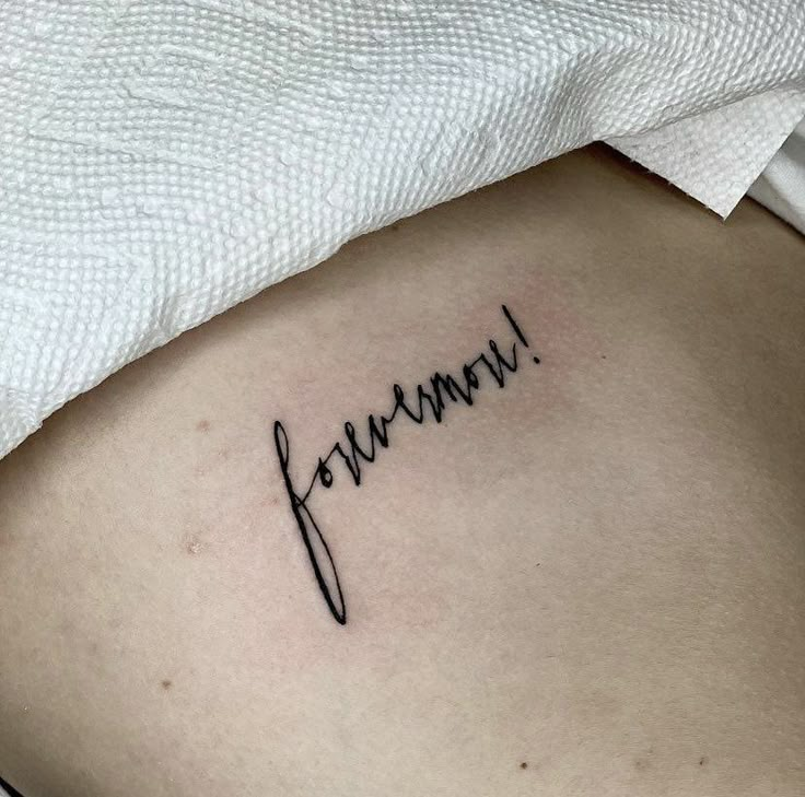 a woman's stomach with the word human written in cursive writing on it