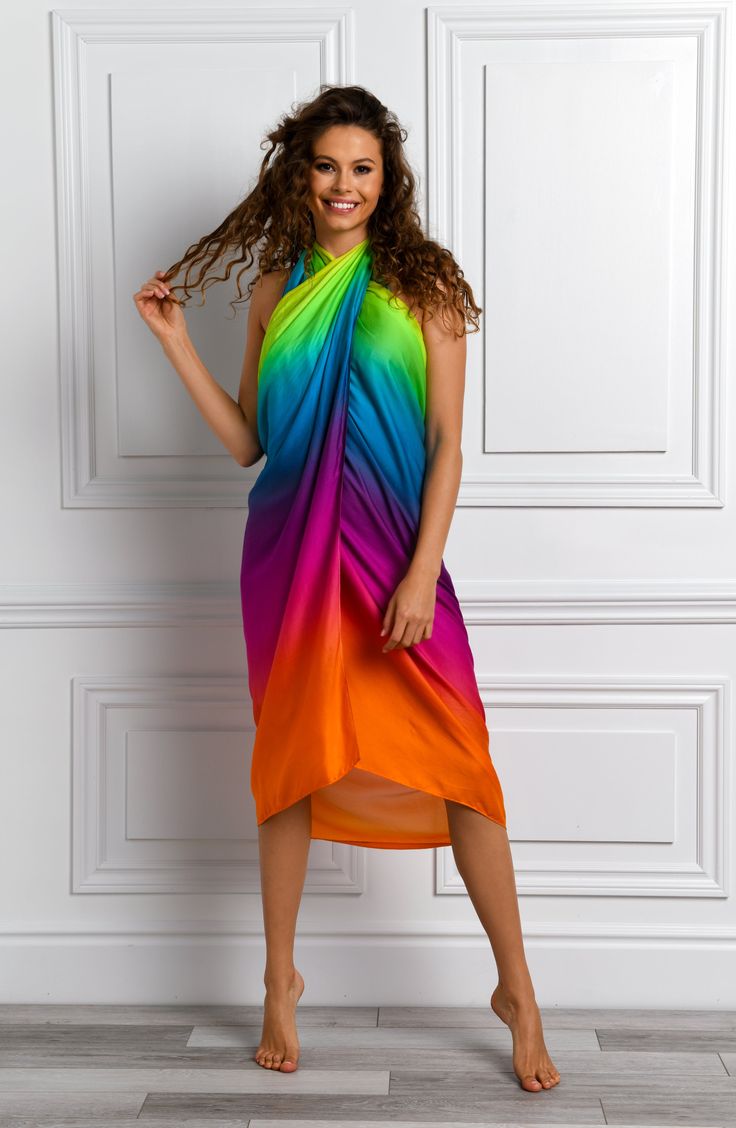 The gradient hues on this cover up seamlessly blend from one shade to another, creating a vibrant and eye-catching look that embodies the spirit of celebration by the water's edge. Perfect for layering over bikini bottoms and one-piece suit alike, this sexy sarong has a one-size-fits all design to ensure a flowy fit. The side tie keeps everything under wraps. [split] Details Pareo Cover Up Adjustable wrap tie One size fits all Fabric 55% Viscose, 45% Rayon Multicolor Sarong For Spring Swimming, Multicolor Sarong For Swimming In Spring, Rainbow Swimwear For The Beach, Rainbow Swimwear For Beach, Rainbow Beachwear Swimwear For Summer, Multicolor Beachwear Cover-up For Swimming, Rainbow Print Swimwear For Summer, Gradient Color Beachwear Swimwear For Beach Season, Rainbow Print Swimwear For Beach