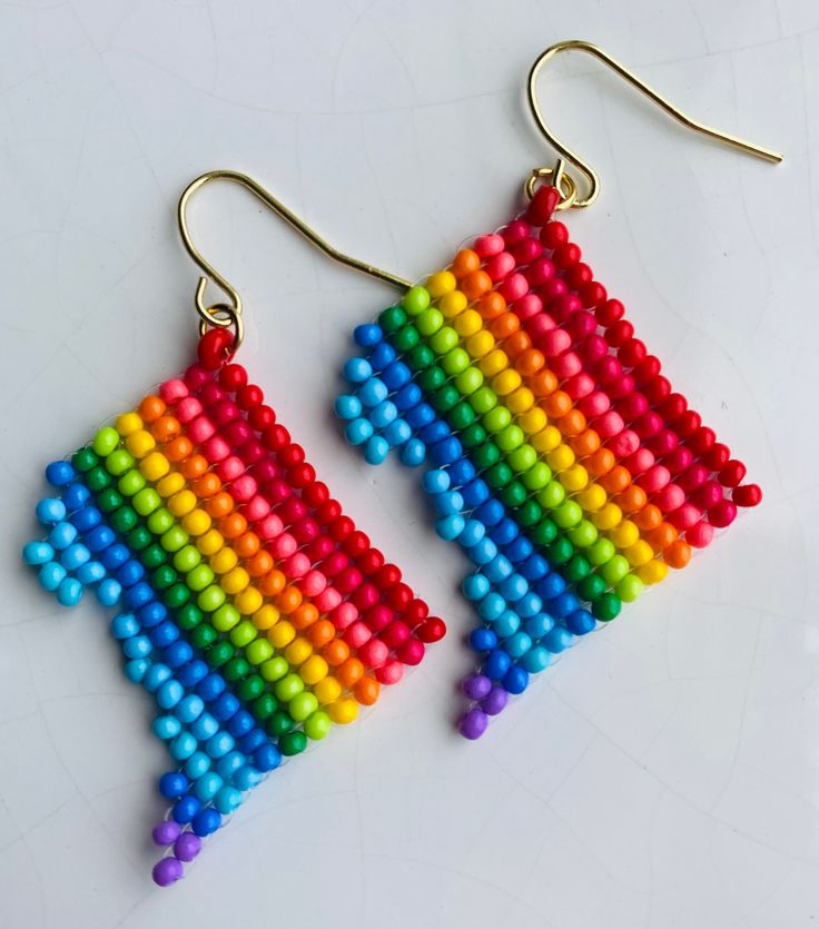 "District of Columbia (DC) shaped rainbow seed bead earrings. Each pair are handmade and lightweight. From tip of hook to bottom of district is 2\". Ear hooks are lead and nickel free." Nickel-free Rainbow Round Beaded Earrings, Rainbow Beaded Earrings With Ear Wire, Handmade Multicolor Heishi Beads Earrings, Rainbow Dangle Earrings With Tiny Beads, Rainbow Earrings With Colorful Beads, Adjustable Rainbow Earrings With Tiny Beads, Rainbow Tiny Beaded Drop Earrings, Rainbow Tiny Beads Drop Earrings, Rainbow Handmade Beaded Dangle Earrings