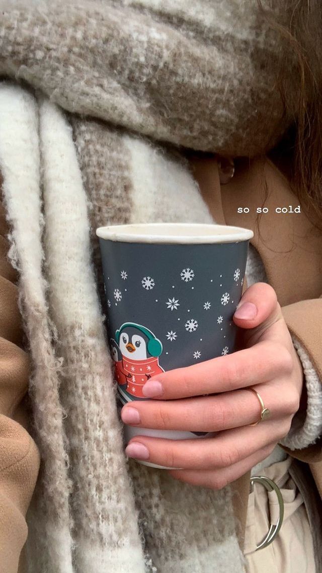 a woman holding a coffee cup in her hands