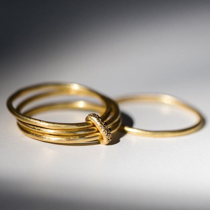 Catbird is proud to debut the work of Prounis, a new jeweler with an old soul. Her modern jewels are inspired by antiquity; each piece is hand wrought from rich, luxurious 22k gold. Made just for us by Prounis ��a very pleasing wedding band option, or a just because ring. Three hand-forged rings are connected by a beaded band, each step drawing on ancient metalsmithing techniques.Prounis jewels are made with a custom shade of the ancient 22-karat alloy; the malleability of 22-karat allows the je Everyday Gold Rings With Single Cut Diamonds, Luxury Gold Stackable Rings With Single Cut Diamonds, Formal Gold Stackable Rings In Recycled Gold, Gold Minimalist Ring With Single Cut Diamonds, Gold Handcrafted Stackable Rings, Yellow Gold Brass Stackable Rings For Wedding, Gold Stackable Rings In Recycled Gold, Fine Jewelry, Gold Heirloom Style Stackable Rings, Heirloom Yellow Gold Stackable Rings In Recycled Gold