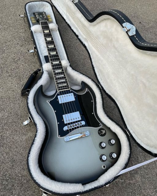 an electric guitar is laying on the ground with its case open and it's ready to be played