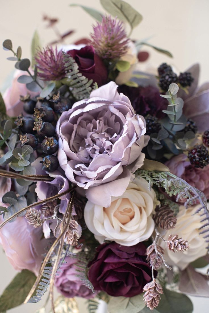 a vase filled with lots of different types of flowers